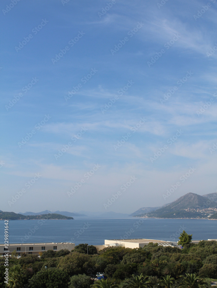 Fototapeta premium Sea, sky and distant mountains portrait