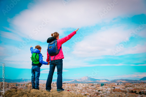 mother and son enjoy travel together, looking at panoramic city view