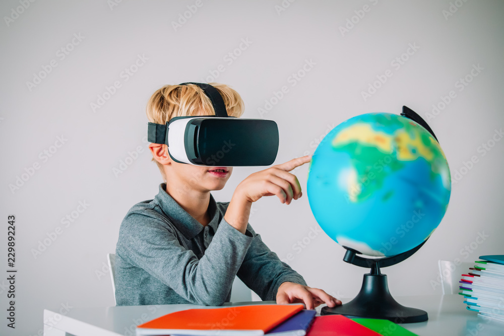 Young kid with virtual reality headset touching earth globe, technology Young kid with virtual reality headset touching earth globe, technology