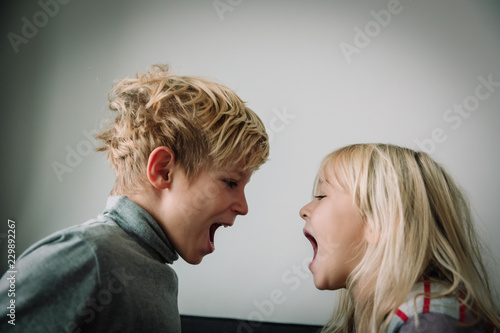 Canvas Print brother and sister shout, concept of rivalry, dispute, anger, disagreement