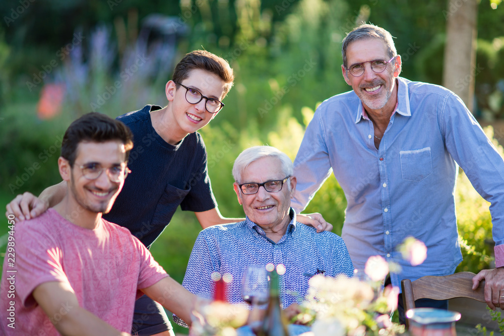 During a family picnic. Portrait of three generation of men During a family picnic. Portrait of three generation of men
