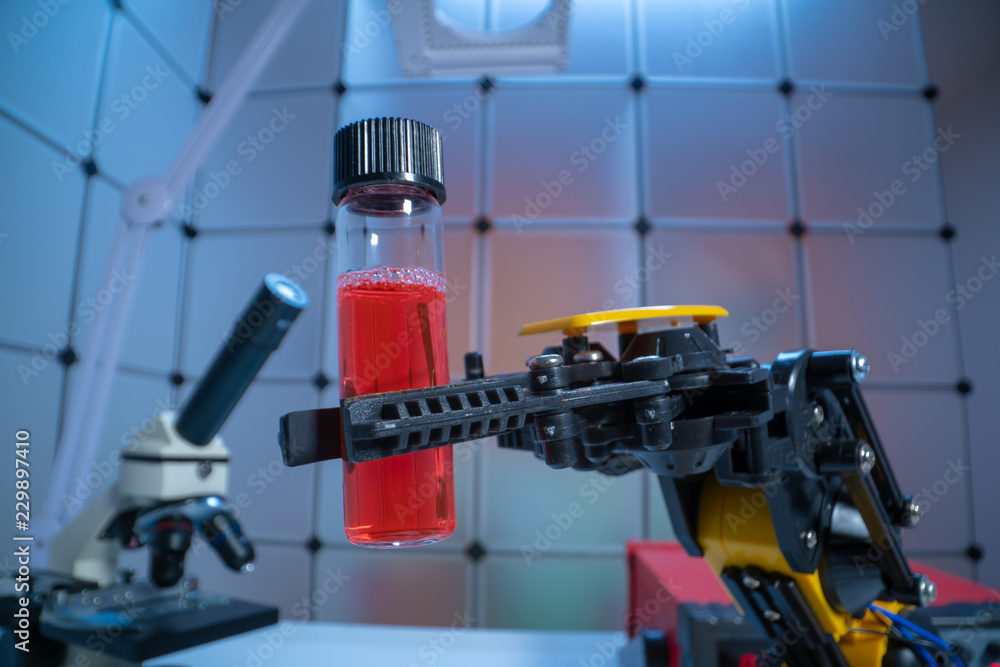 Test tube in robot arm. robot manipulates chemical tubes in the laboratory Test tube in robot arm. robot manipulates chemical tubes in the laboratory