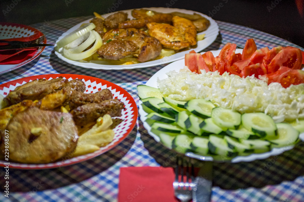 Mixed grilled meat platter Snack, sausages, shank, pork ribs, cutlets, and steaks on the grill Assorted delicious grilled meat with vegetable Mix of various types of barbecue meat decorated with salad Mixed grilled meat platter Snack, sausages, shank, pork ribs, cutlets, and steaks on the grill Assorted delicious grilled meat with vegetable Mix of various types of barbecue meat decorated with salad