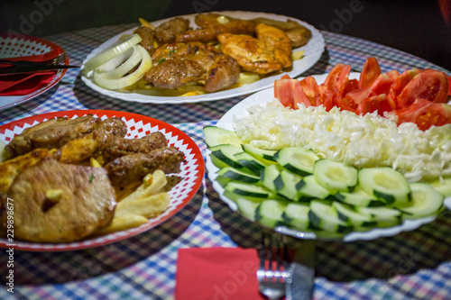 Mixed grilled meat platter Snack, sausages, shank, pork ribs, cutlets, and steaks on the grill Assorted delicious grilled meat with vegetable Mix of various types of barbecue meat decorated with salad