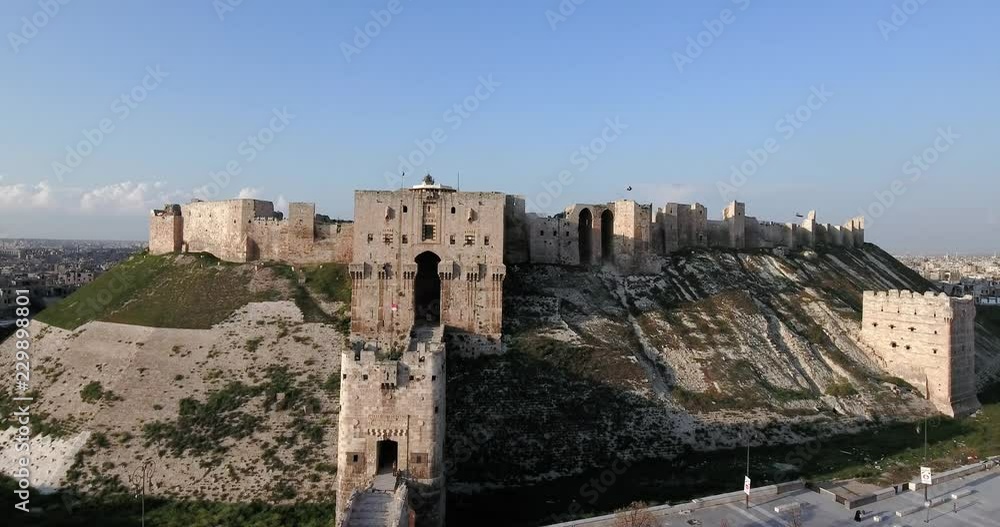 Aerial view of Citadel of Aleppo with cityscape against sky Aerial view of Citadel of Aleppo with cityscape against sky
