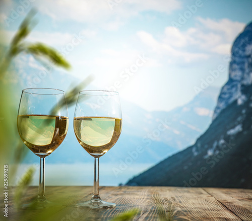 two single glasses of wine wiht free space for your bottle and blurred background. 
