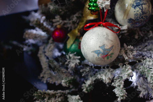 Blue lights Christmas tree with a DIY ball with a bird