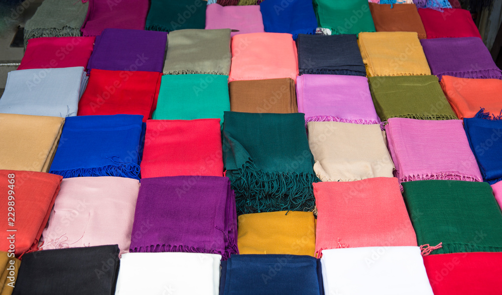 Fototapeta premium Colorful scarfs on busy shopping street