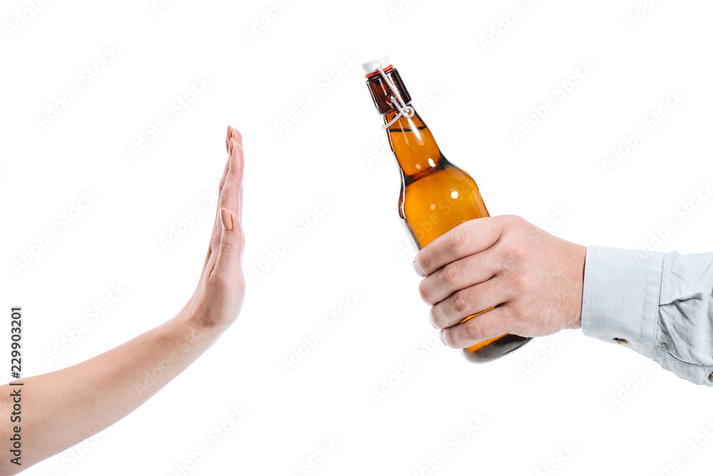 cropped image of woman rejecting bottle of beer isolated on white cropped image of woman rejecting bottle of beer isolated on white