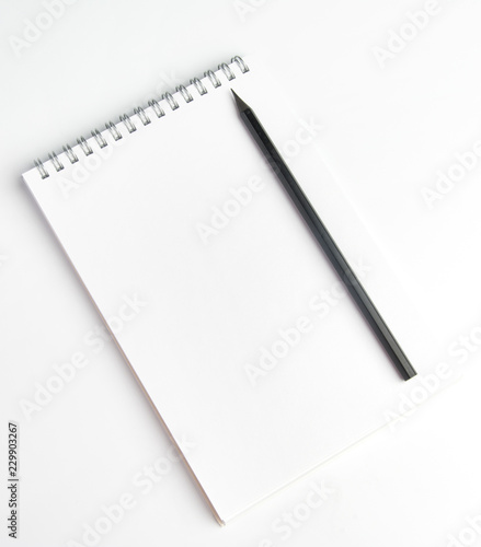 The pencil is on the notebook of the student.