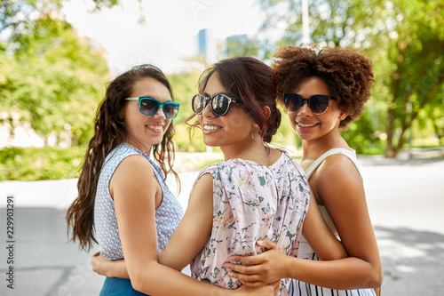 female friendship  people and leisure - happy young women in sunglasses at summer park