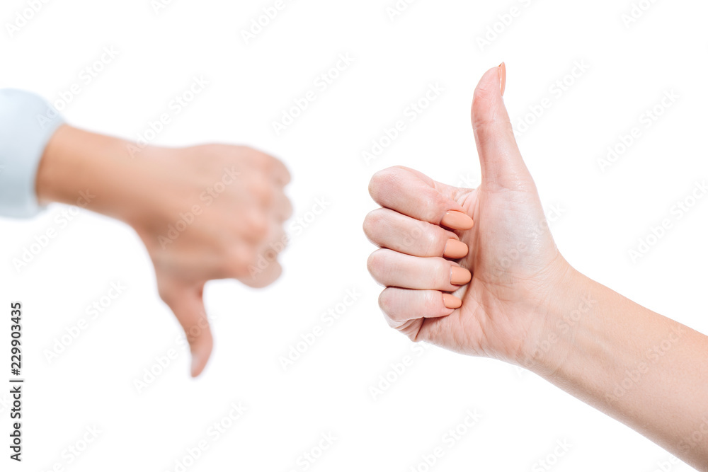 selective focus of woman and man showing thumb up and thumb down isolated on white selective focus of woman and man showing thumb up and thumb down isolated on white