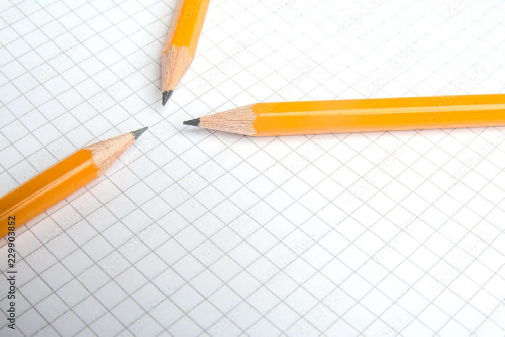 The pencil lying on the notebook. Close up. The pencil lying on the notebook. Close up.