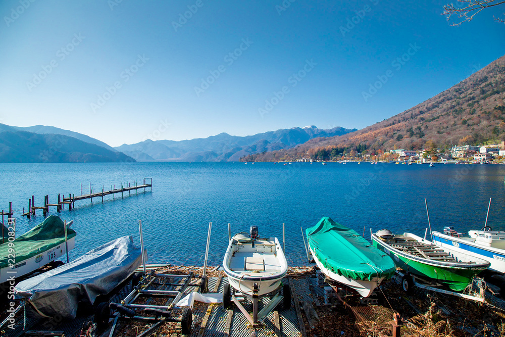 Clear sky with panorama lake view with duck boats and mountain background in Autumn season at Lake Chuzenji, Nikko tochigi Prefecture, Japan