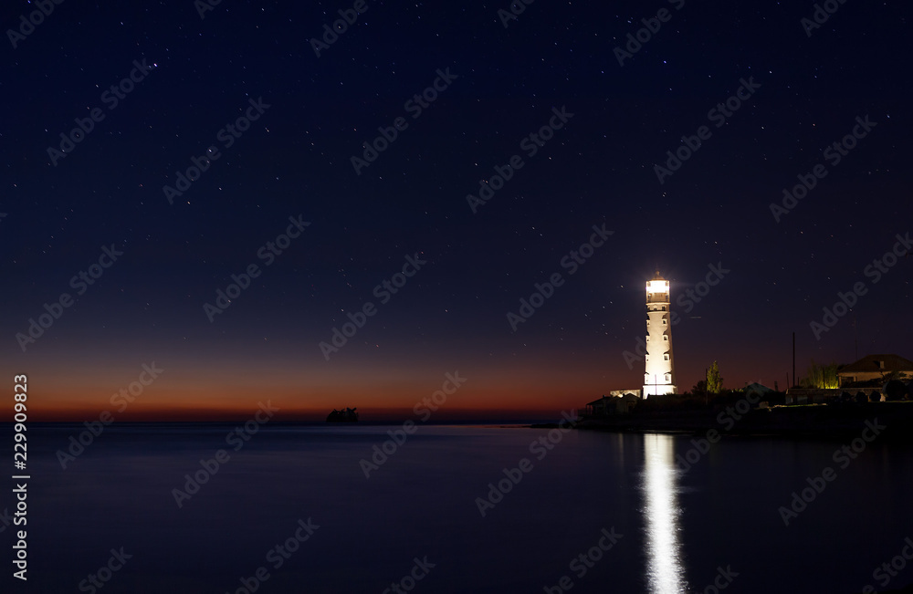Lighthouse at cape Tarkhankut, Crimea on starry night