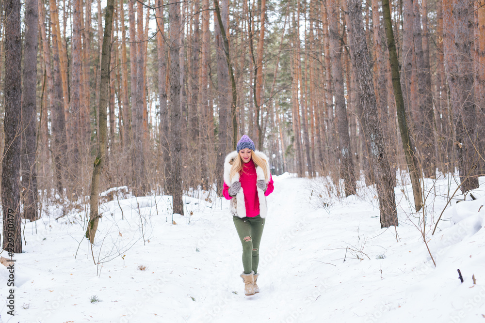 Nature and people concept - Portrait of running young blond woman in the winter park