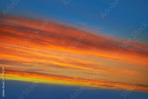 Sunset clouds sky in orange and blue © lunamarina