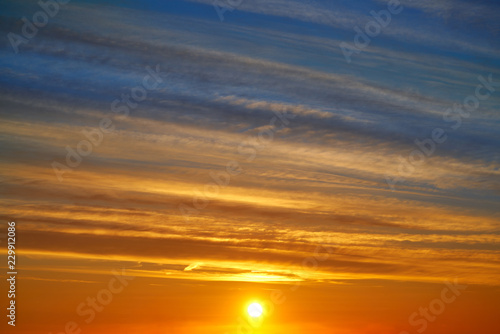 Sunset clouds sky in orange and blue © lunamarina