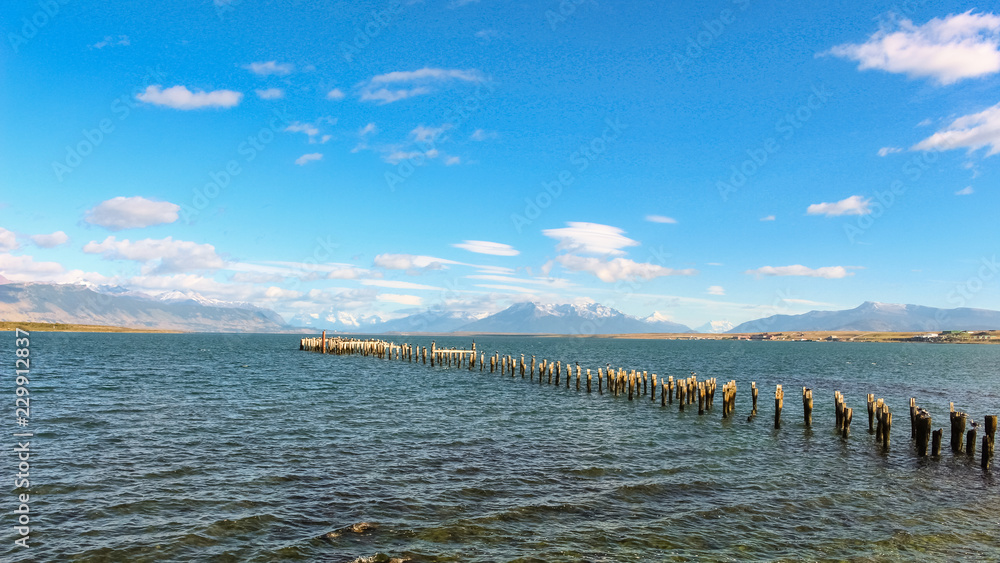 Patagonia bay and mountains from Puerto Natales with cormorants on old pilings