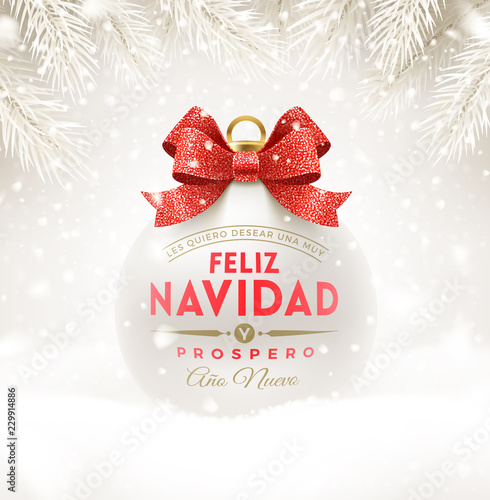 Feliz navidad - Christmas greetings in Spanish. Christmas white bauble with glitter red bow ribbon and type design. Christmas ball on a snow. Vector illustration.