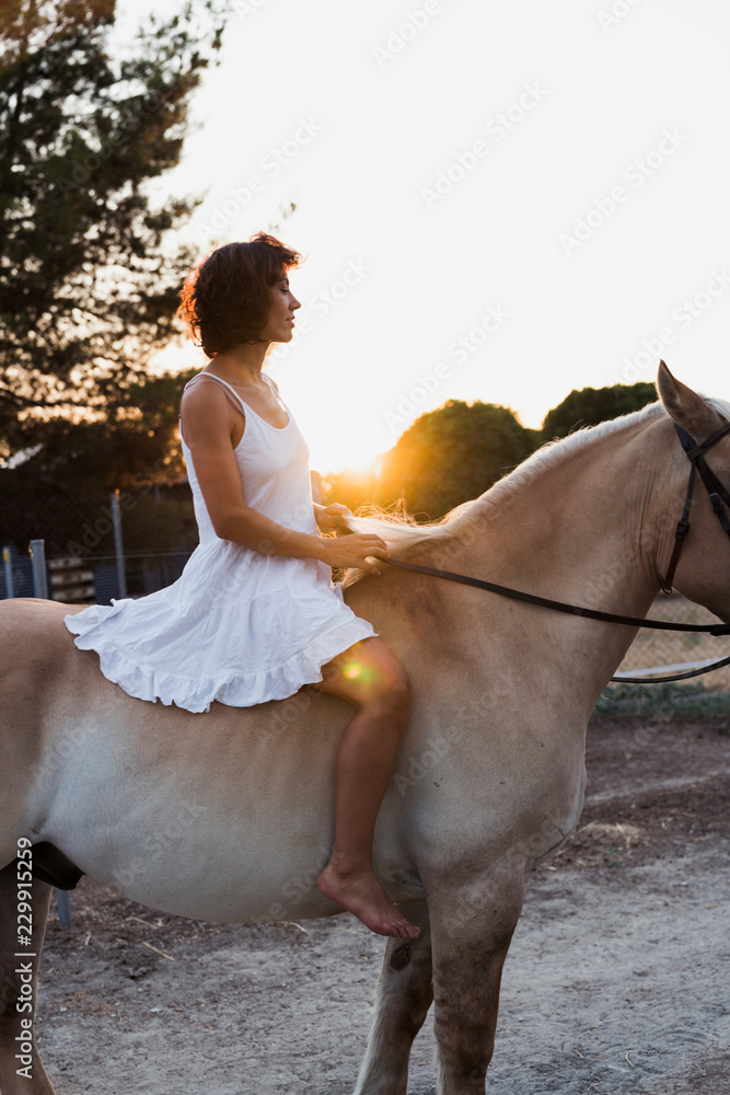 Barefoot woman riding bareback on horse Stock Photo | Adobe Stock