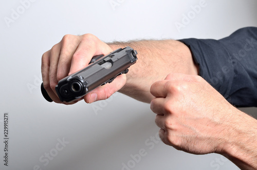 Man threats with gun, threating gesture