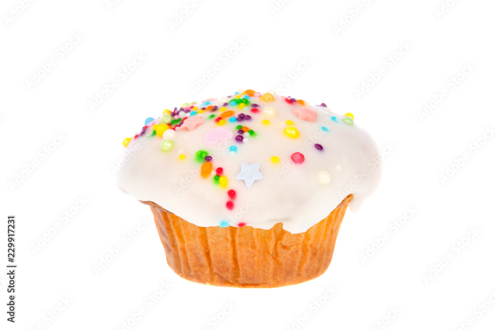 Delicious homemade muffin with white fondant and colorful sugar sprinkles icing isolated on white background.
