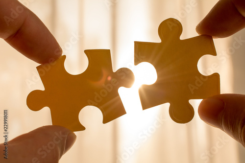 couple puzzle piece with sunset background. symbol of association and connection, business strategy concept