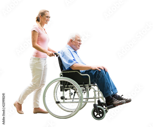 Happy Woman Assisting Her Disabled Father On Wheelchair