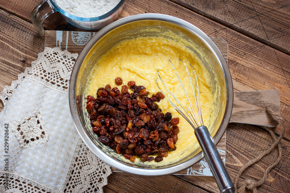 Step-by-step preparation of a raisin cake - mixing the necessary ingredients, top view Step-by-step preparation of a raisin cake - mixing the necessary ingredients, top view