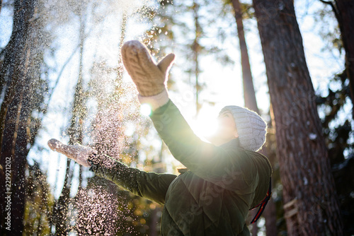 Wallpaper Mural Joy of a winter day. Woman in winter clothes playing with fresh snow in the forest on a Sunny day, bright sun, selective focus, freezing movement Torontodigital.ca