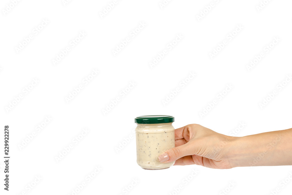 Creamy sauce with truffle for pasta in glass jar isolated on white background, with hand, copy space template Creamy sauce with truffle for pasta in glass jar isolated on white background, with hand, copy space template