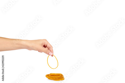Yellow rubber bands close up with hand isolated on white background, copy space template.