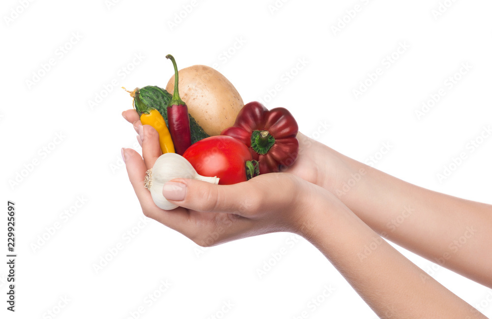Woman holding vegetable assortment isolated on white background Woman holding vegetable assortment isolated on white background