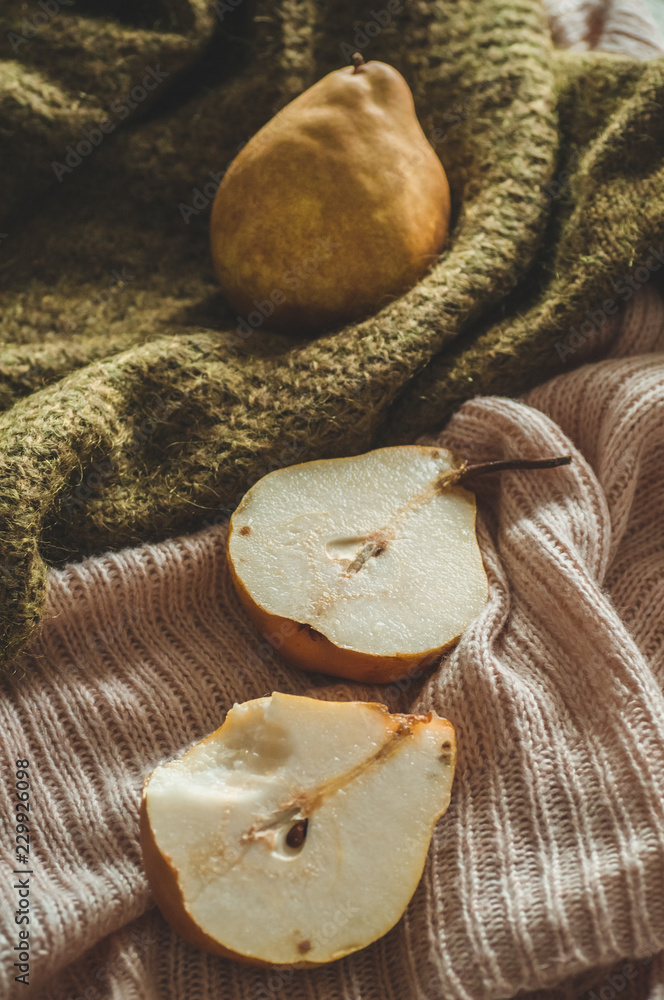 Autumn nature concept. Fall pears on knitted sweaters. Thanksgiving dinner Autumn nature concept. Fall pears on knitted sweaters. Thanksgiving dinner