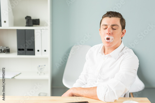 Joke, humor, office, people concept - man chewing the gum while he is working, gum splitted