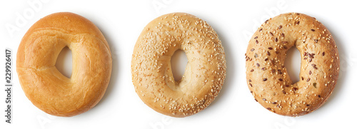 Fresh bagels on white background, from above
