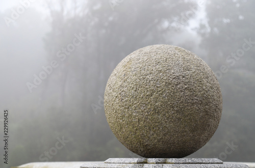 Closeup of an outdoor sphere marble stone work with natural and cloudy sky background.