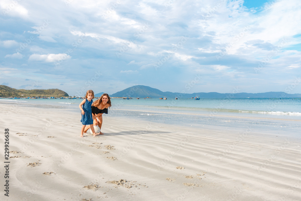 mother and daughter hugging on the beach mother and daughter hugging on the beach