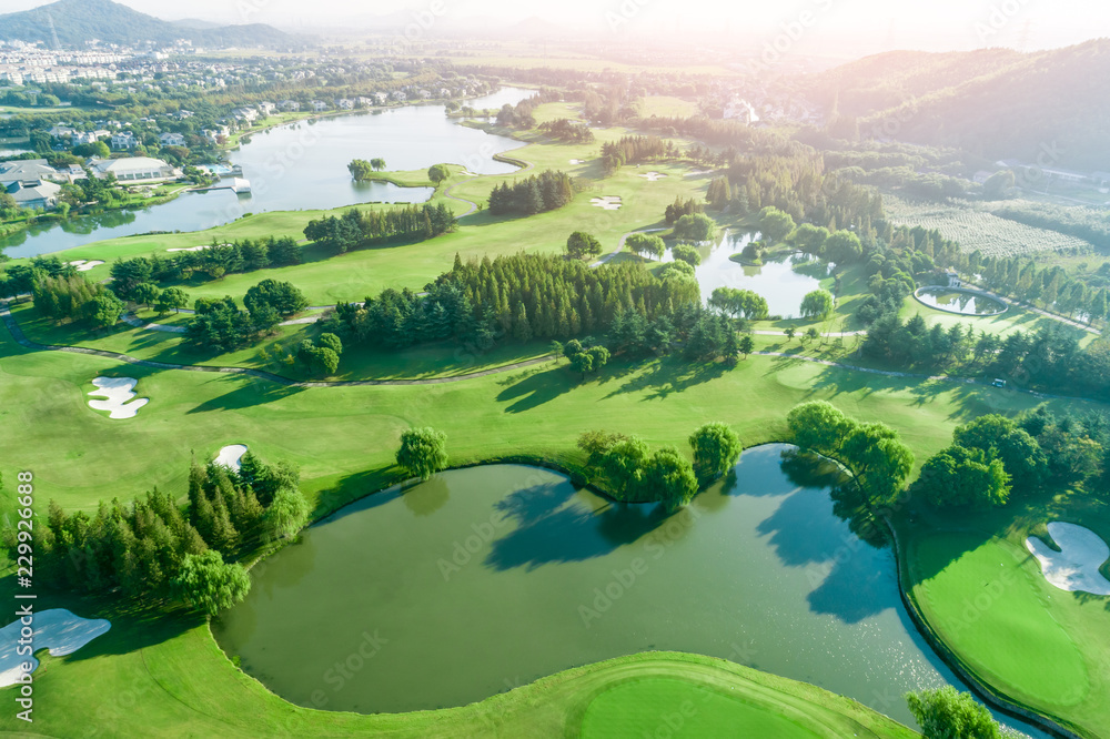 Aerial photograph of forest and golf course with lake