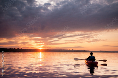 Man in a kayak on the river on the scenic sunset © MIRACLE MOMENTS