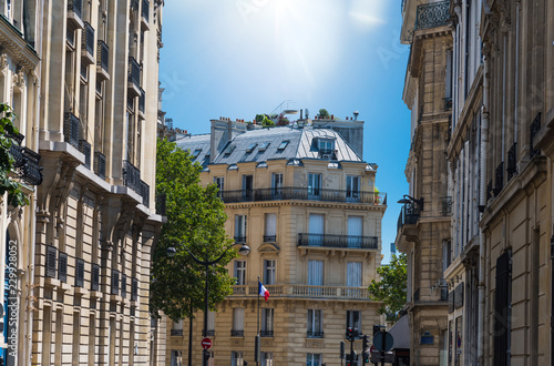 Sun shining over elegant buildings in Paris