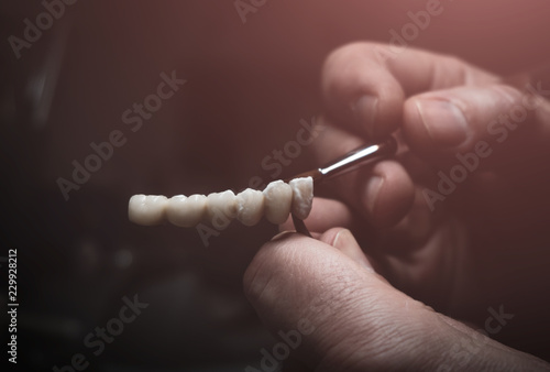 A dental technician makes a prosthetic teeth. laboratory. close-up. photo