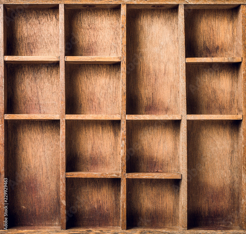 Empty wooden box with compartments, top view.