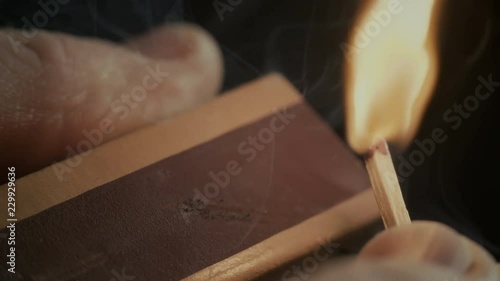 Ignition of match with smoke, isolated on black background.
