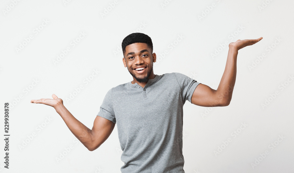 Young black man making scale with his hands Young black man making scale with his hands