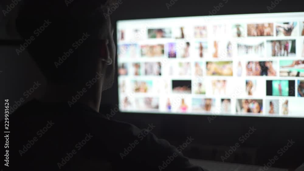 Young mand watching naked women in the computer screen Young mand watching naked women in the computer screen