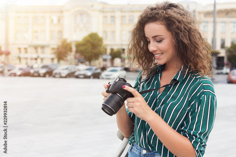 Charming female photographer taking photos during city walk Charming female photographer taking photos during city walk