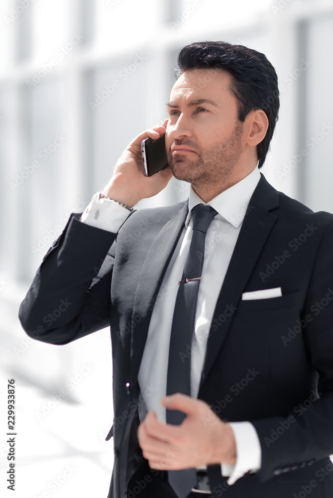 responsible businessman talking on a mobile phone responsible businessman talking on a mobile phone