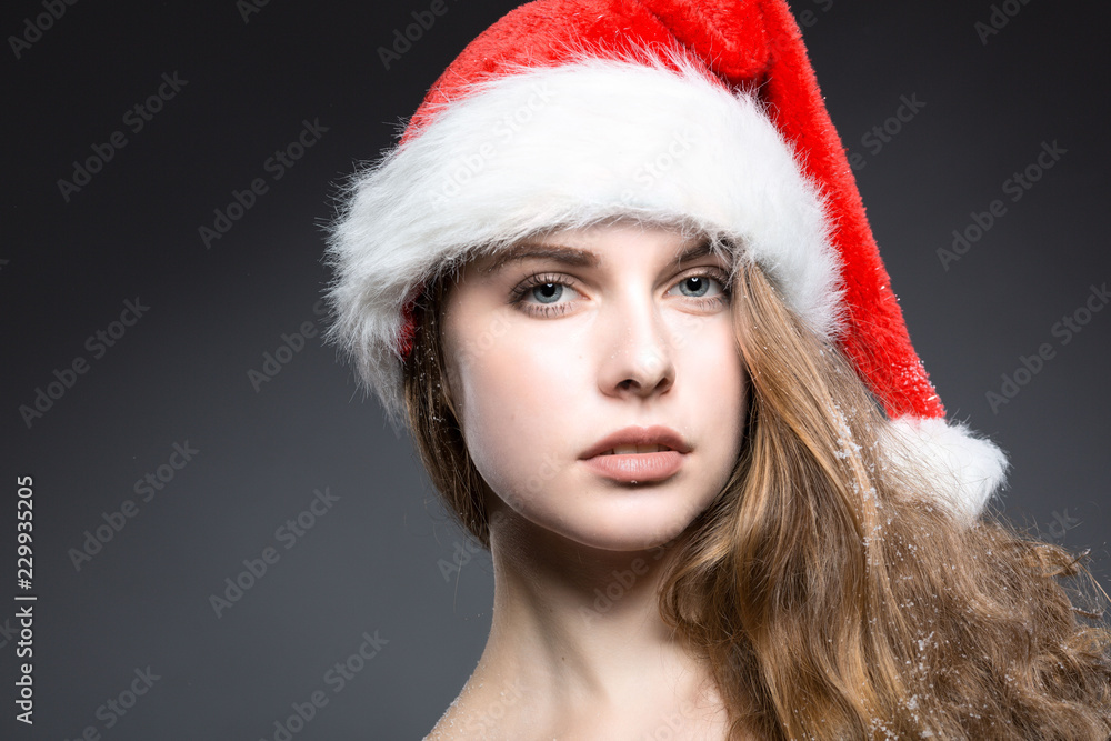 Hübsche junge Frau mit einer Weihnachtsmütze Hübsche junge Frau mit einer Weihnachtsmütze